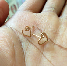 Load image into Gallery viewer, Gold Heart Stud Earrings. 14k Gold Swirly Heart Studs. Spiral Heart Stud Post Earrings. 14k gold filled hearts. AzizaJewelry