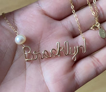 Load and play video in Gallery viewer, Custom Gold Name Necklace with Off White Freshwater Pearl. Personalized Pearl Name Necklace in 14k Gold. Script Name Brooklyn Necklace Pearl
